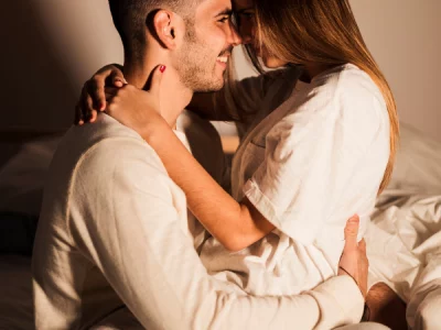 Couple proche qui se regarde en souriant, article "parler cochon pendant l’acte"